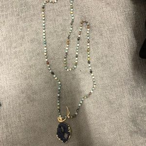 Long beaded necklace with large stone at end